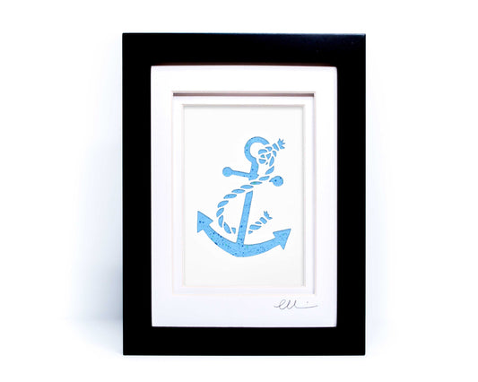 White nautical anchor twisted with rope papercut on hand painted light blue splattered background.