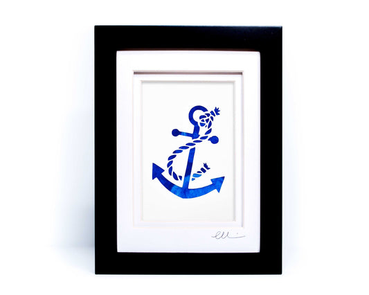 White nautical anchor twisted with rope papercut on hand painted blue background.