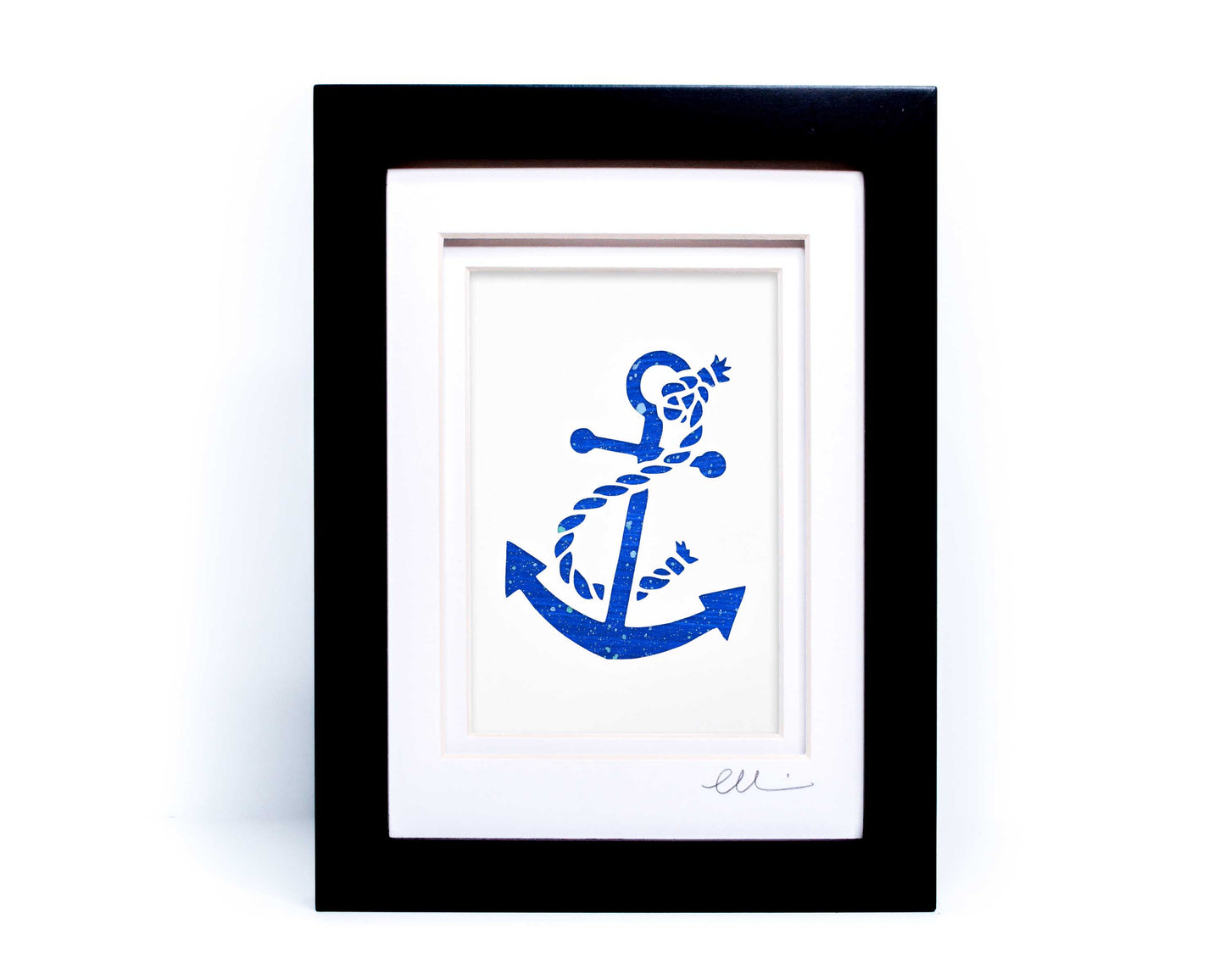 White nautical anchor twisted with rope papercut on hand painted bright blue splattered background.