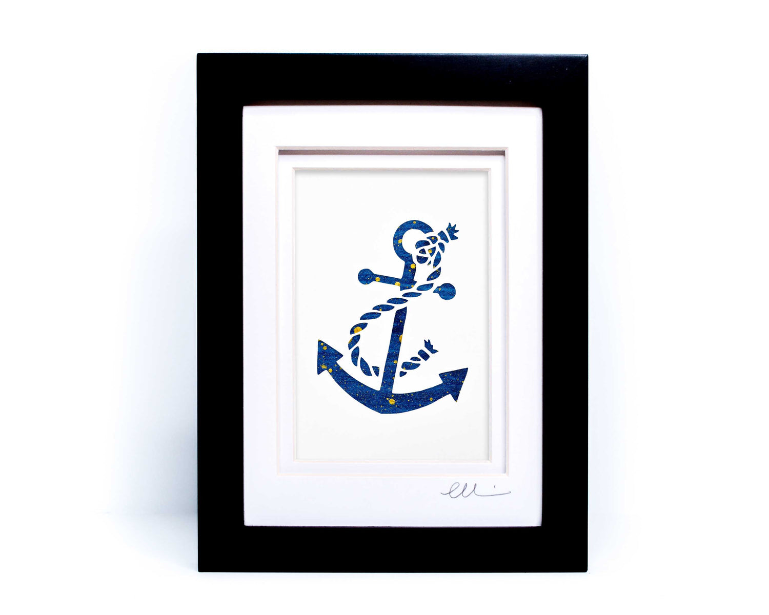 White nautical anchor twisted with rope papercut on hand painted dark blue background.